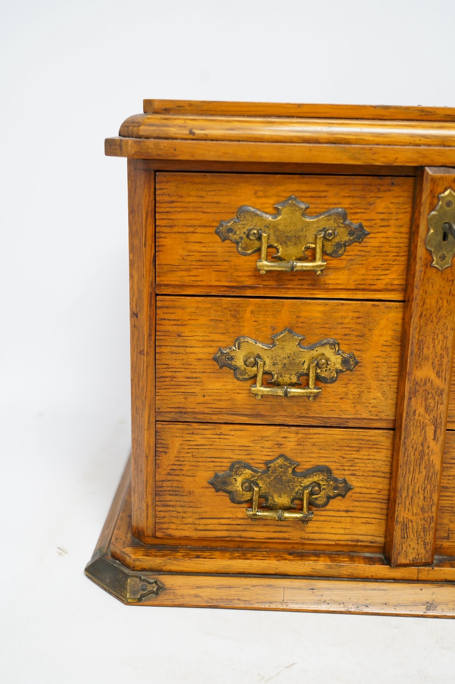 An early 20th century oak collector's cabinet, retailer Fisher, 188 Strand, 38cm wide. Condition - fair